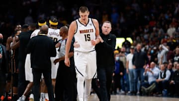 Denver Nuggets head coach Michael Malone pulls center Nikola Jokic (15) away from a scrum in the fourth quarter against the Miami Heat at Ball Arena on 8 Nov. 2021. (Isaiah J. Downing-USA TODAY Sports)