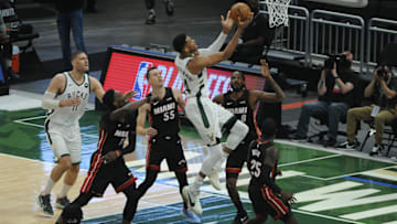 May 24, 2021; Milwaukee, Wisconsin, USA; Milwaukee Bucks forward Giannis Antetokounmpo (34) drives to the basket against Miami Heat forward Trevor Ariza (8) and guard Duncan Robinson (55) in the first quarter during game 2 in the first round of the 2021 NBA Playoffs at Fiserv Forum. Mandatory Credit: Michael McLoone-USA TODAY Sports