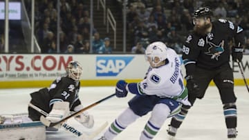 Mar 31, 2016; San Jose, CA, USA; Vancouver Canucks left wing Alex Burrows (14) shoots the puck against San Jose Sharks goalie Martin Jones (31) in front of Sharks defenseman Brent Burns (88) in the second period at SAP Center at San Jose. Mandatory Credit: Kenny Karst-USA TODAY Sports