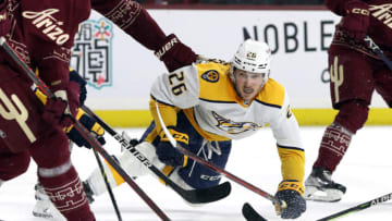 TEMPE, ARIZONA - MARCH 09: Philip Tomasino #26 of the Nashville Predators falls to the ice while skating for a loose puck against the Arizona Coyotes during the third period at Mullett Arena on March 09, 2023 in Tempe, Arizona. (Photo by Zac BonDurant/Getty Images)