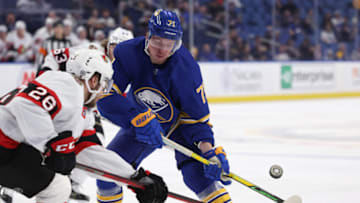 Feb 17, 2022; Buffalo, New York, USA; Ottawa Senators defenseman Erik Brannstrom (26) and Buffalo Sabres left wing Victor Olofsson (71) look to control a loose puck during the second period at KeyBank Center. Mandatory Credit: Timothy T. Ludwig-USA TODAY Sports