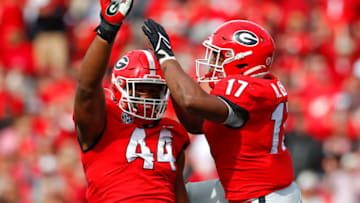 Travon Walker reacts after a sack with Nakobe Dean. (Photo by Todd Kirkland/Getty Images)