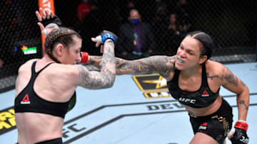 LAS VEGAS, NEVADA - MARCH 06: In this handout image provided by UFC, (R-L) Amanda Nunes of Brazil punches Megan Anderson of Australia in their UFC featherweight championship fight during the UFC 259 event at UFC APEX on March 06, 2021 in Las Vegas, Nevada. (Photo by Jeff Bottari/Zuffa LLC via Getty Images)