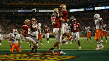 MIAMI - JANUARY 1: Quarterback Chris Rix #16 and Matt Meinrod #64 of the Florida State Seminoles celebrate in the end zone during the 2004 Orange Bowl game against the Miami Hurricanes on January 1, 2004 at Pro Player Stadium in Miami, Florida. Miami defeated Forida State 16-14. (Photo by Jamie Squire/Getty Images)