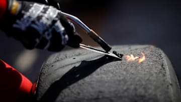 DAYTONA BEACH, FLORIDA - FEBRUARY 21: The #23 DoorDash Toyota crew work on tires during the NASCAR Cup Series O'Reilly Auto Parts 253 at Daytona International Speedway on February 21, 2021 in Daytona Beach, Florida. (Photo by Chris Graythen/Getty Images)