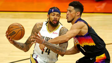 New Orleans Pelicans forward Brandon Ingram (14) drives to the basket against Phoenix Suns guard Devin Booker (1) Credit: Mark J. Rebilas-USA TODAY Sports