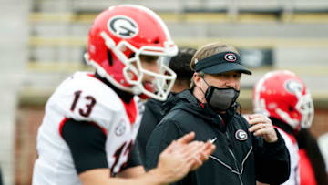 Georgia Bulldogs head coach Kirby Smart looks on as quarterback Stetson Bennett (13) warms up - Mandatory Credit: Jay Biggerstaff-USA TODAY Sports