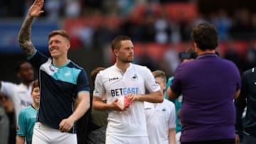 SWANSEA, WALES - MAY 21: Swansea players Alfie Mawson (l) and Gylfi Sigurdsson applauds the fans after the Premier League match between Swansea City and West Bromwich Albion at Liberty Stadium on May 21, 2017 in Swansea, Wales. (Photo by Stu Forster/Getty Images)