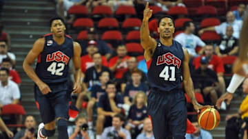 Aug 1, 2014; Las Vegas, NV, USA; USA Team Blue Derrick Rose (41) calls a play while dribbling the ball during the USA Basketball Showcase atThomas & Mack Center. Trailing the play is center Anthony Davis (42). Mandatory Credit: Stephen R. Sylvanie-USA TODAY Sports