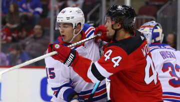 New Jersey Devils left wing Miles Wood (44) hits New York Rangers defenseman Braden Schneider (45) during the second period at Prudential Center. Mandatory Credit: Ed Mulholland-USA TODAY Sports