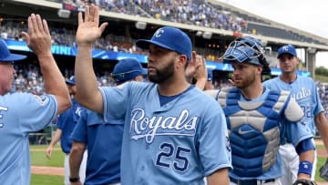 Aug 7, 2016; Kansas City, MO, USA; Kansas City Royals designated hitter Kendrys Morales (25) and catcher Drew Butera (9) are congratulated by team mates after the win over the Toronto Blue Jays at Kauffman Stadium. The Royals won 7-1. Mandatory Credit: Denny Medley-USA TODAY Sports