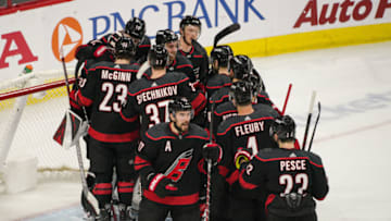 RALEIGH, NC - MAY 03: Carolina Hurricanes surround Carolina Hurricanes goaltender Curtis McElhinney (35) after sweeping the New York Islanders after a game between the Carolina Hurricanes and the New York Islanders on March 3, 2019 at the PNC Arena in Raleigh, NC. (Photo by Greg Thompson/Icon Sportswire via Getty Images)