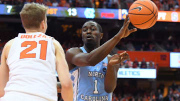 SYRACUSE, NY - FEBRUARY 21: Theo Pinson #1 of the North Carolina Tar Heels passes the ball in front of Marek Dolezaj #21 of the Syracuse Orange during the first half at the Carrier Dome on February 21, 2018 in Syracuse, New York. North Carolina defeated Syracuse 78-74. (Photo by Rich Barnes/Getty Images)