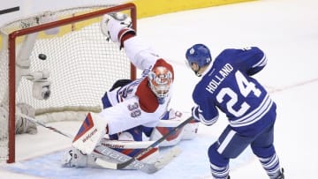 Jan 23, 2016; Toronto, Ontario, CAN; Toronto Maple Leafs center Peter Holland (24) scores a goal past Montreal Canadiens goalie Mike Condon (39) in the shootout at Air Canada Centre. The Canadiens won 3-2. Mandatory Credit: Tom Szczerbowski-USA TODAY Sports