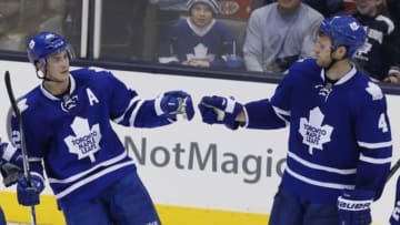 Nov 22, 2014; Toronto, Ontario, CAN; Toronto Maple Leafs defenceman Cody Franson (4) congratulates forward Tyler Bozak (42) on Bozak