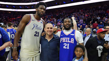 PHILADELPHIA, PA - APRIL 24: (L-R) Joel Embiid #21 of the Philadelphia 76ers, co-owner Michael Rubin, Meek Mill and his son Papi pose for a photograph after the game against the Miami Heat at Wells Fargo Center on April 24, 2018 in Philadelphia, Pennsylvania. The 76ers won 104-91. (Photo by Drew Hallowell/Getty Images)