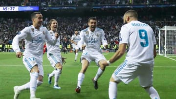 Real Madrid's French forward Karim Benzema (R) celebrates with Real Madrid's Spanish midfielder Lucas Vazquez (L), Real Madrid's Croatian midfielder Luka Modric (C) and Real Madrid's Croatian midfielder Mateo Kovacic after scoring a second goal during the UEFA Champions League semi-final second leg football match between Real Madrid and Bayern Munich at the Santiago Bernabeu Stadium in Madrid on May 1, 2018. (Photo by OSCAR DEL POZO / AFP) (Photo credit should read OSCAR DEL POZO/AFP/Getty Images)