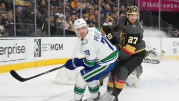 Apr 6, 2022; Las Vegas, Nevada, USA; Vegas Golden Knights defenseman Shea Theodore (27) covers Vancouver Canucks left wing Tanner Pearson (70) during the first period at T-Mobile Arena. Mandatory Credit: Stephen R. Sylvanie-USA TODAY Sports