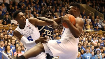 DURHAM, NORTH CAROLINA - JANUARY 26: Teammates Zion Williamson #1 and RJ Barrett #5 of the Duke Blue Devils battle for a loose ball against Abdoulaye Gueye #34 of the Georgia Tech Yellow Jackets during their game at Cameron Indoor Stadium on January 26, 2019 in Durham, North Carolina. (Photo by Streeter Lecka/Getty Images)