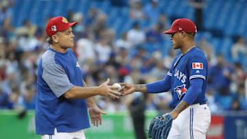 TORONTO, ON - JULY 4: Marcus Stroman #6 of the Toronto Blue Jays hands the baseball to manager John Gibbons #5 as he is relieved in the fifth inning during MLB game action against the New York Mets at Rogers Centre on July 4, 2018 in Toronto, Canada. (Photo by Tom Szczerbowski/Getty Images)