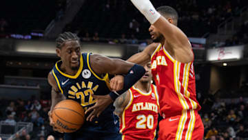 Dec 1, 2021; Indianapolis, Indiana, USA; Indiana Pacers guard Caris LeVert (22) looks to shoot the ball while Atlanta Hawks guard Timothe Luwawu-Cabarrot (7) defends in the second half at Gainbridge Fieldhouse. Mandatory Credit: Trevor Ruszkowski-USA TODAY Sports