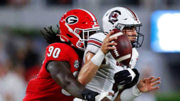 ATHENS, GA - SEPTEMBER 18: Luke Doty #4 of the South Carolina Gamecocks is pressured by Tramel Walthour #90 of the Georgia Bulldogs during the first half at Sanford Stadium on September 18, 2021 in Athens, Georgia. (Photo by Todd Kirkland/Getty Images)