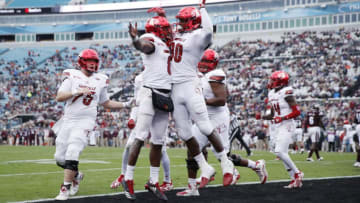 JACKSONVILLE, FL - DECEMBER 30: Lamar Jackson #8 of the Louisville Cardinals celebrates with teammate Charles Standberry #80 after running for a touchdown in the first half of the TaxSlayer Bowl against the Mississippi State Bulldogs at EverBank Field on December 30, 2017 in Jacksonville, Florida. (Photo by Joe Robbins/Getty Images)