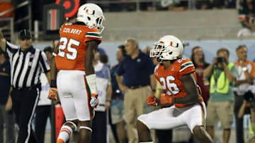 Dec 28, 2016; Orlando, FL, USA; Miami Hurricanes defensive back Rayshawn Jenkins (26) celebrates with defensive back Adrian Colbert (25) after a play in the second half against the West Virginia Mountaineers at Camping World Stadium. The Miami Hurricanes won 31-14. Mandatory Credit: Logan Bowles-USA TODAY Sports