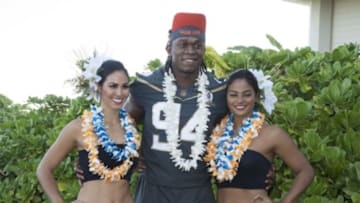 January 29, 2016; Kahuku, HI, USA; Hawaiian hostesses Chelsea Hardin (far left) and Mahina Garcia (far right) pose with Team Irvin defensive end Ezekiel Ansah of the Detroit Lions (94) during 2016 Pro Bowl photo day at Turtle Bay Resort. Mandatory Credit: Kyle Terada-USA TODAY Sports