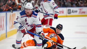 EDMONTON, AB - NOVEMBER 05: Alexis Lafreniere #13 of the New York Rangers skates against Slater Koekkoek #20 of the Edmonton Oilers during the first period at Rogers Place on November 5, 2021 in Edmonton, Canada. (Photo by Codie McLachlan/Getty Images)