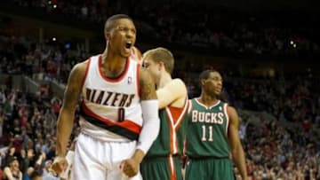 Mar 18, 2014; Portland, OR, USA; Portland Trail Blazers guard Damian Lillard (0) reacts after dunking the ball against Milwaukee Bucks in overtime at Moda Center. Mandatory Credit: Jaime Valdez-USA TODAY Sports