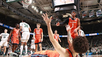 EAST LANSING, MI - FEBRUARY 19: Andre Curbelo #5 of the Illinois Fighting Illini falls to the floor and helped up by teammate Trent Frazier #1 of the Illinois Fighting Illini in the second half of the game against the Michigan State Spartans at Breslin Center on February 19, 2022 in East Lansing, Michigan. (Photo by Rey Del Rio/Getty Images)