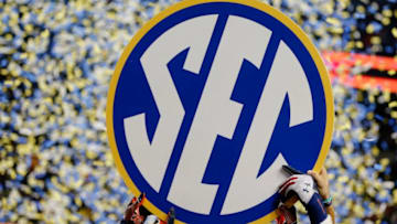ATLANTA, GA - DECEMBER 07: The Auburn Tigers hold up the SEC sign in celebration after defeating the Missouri Tigers 59-42 to win the SEC Championship Game at Georgia Dome on December 7, 2013 in Atlanta, Georgia. (Photo by Kevin C. Cox/Getty Images)