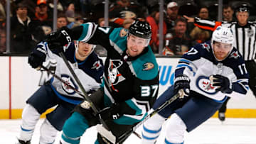 ANAHEIM, CA - MARCH 20: Nick Ritchie #37 of the Anaheim Ducks skates with the puck with pressure from Adam Lowry #17 of the Winnipeg Jets during the game on March 20, 2019 at Honda Center in Anaheim, California. (Photo by Debora Robinson/NHLI via Getty Images)
