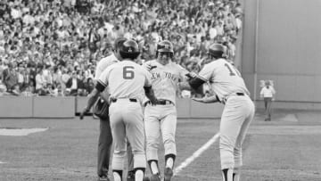 (Original Caption) Bucky Dent is a happy fellow as he jumps on home plate and is greeted by Roy White and Chris Chambliss after he hit a three-run home run in the 7th inning at Fenway Park.