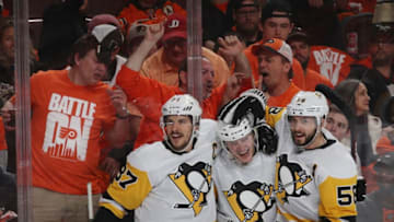 Jake Guentzel #59, Sidney Crosby #87, and Kris Letang #58 of the Pittsburgh Penguins. (Photo by Bruce Bennett/Getty Images)