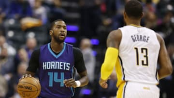 Dec 12, 2016; Indianapolis, IN, USA; Charlotte Hornerts forward Michael Kidd-Gilchrist (14) brings the ball up court against Indiana Pacers forward Paul George (13) at Bankers Life Fieldhouse. Mandatory Credit: Brian Spurlock-USA TODAY Sports