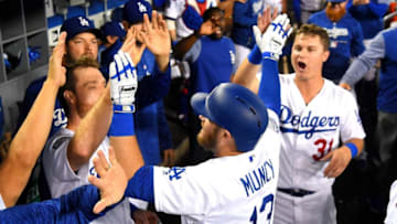 LOS ANGELES, CA - JUNE 08: Max Muncy #13 is greeted in the dugout by Logan Forsythe #11 and Joc Pederson #31 of the Los Angeles Dodgers after a solo home run in the fifth inning of the game against the Atlanta Braves at Dodger Stadium on June 8, 2018 in Los Angeles, California. (Photo by Jayne Kamin-Oncea/Getty Images)