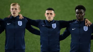 ANDORRA LA VELLA, ANDORRA - OCTOBER 09: James Ward-Prowse, Phil Foden and Bukayo Saka of England line up for the national anthem during the 2022 FIFA World Cup Qualifier match between Andorra and England at Estadi Nacional on October 09, 2021 in Andorra la Vella, Andorra. (Photo by David Ramos/Getty Images)