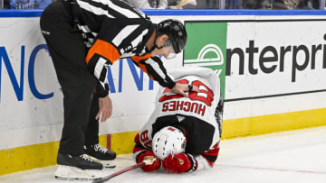 New Jersey Devils center Jack Hughes (86) is checked on by referee Dan O'Rourke (9) after slamming in to the boards during the first period against the St. Louis Blues at Enterprise Center. Mandatory Credit: Jeff Curry-USA TODAY Sports