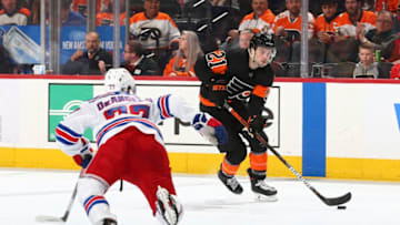 PHILADELPHIA, PA - FEBRUARY 28: Scott Laughton #21 of the Philadelphia Flyers controls the puck against Tony DeAngelo #77 of the New York Rangers in the third period at the Wells Fargo Center on February 28, 2020 in Philadelphia, Pennsylvania. The Flyers defeated the Rangers 5-2. (Photo by Mitchell Leff/Getty Images)