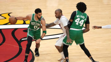 Jayson Tatum #0 of the Boston Celtics dribbles against P.J. Tucker #17 of the Miami Heat(Photo by Eric Espada/Getty Images)