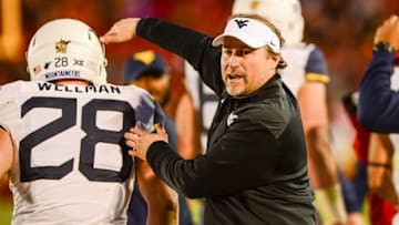 Nov 26, 2016; Ames, IA, USA; West Virginia Mountaineers head coach Dana Holgorsen congratulates his team after a touchdown during the second half against the Iowa State Cyclones at Jack Trice Stadium. West Virginia won 49-19. Mandatory Credit: Jeffrey Becker-USA TODAY Sports