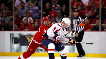 DETROIT, MI - FEBRUARY 18: Dmitry Orlov #9 of the Washington Capitals battles for the puck with Luke Glendening #41 of the Detroit Red Wings at Joe Louis Arena on February 18, 2017 in Detroit, Michigan. (Photo by Gregory Shamus/Getty Images)