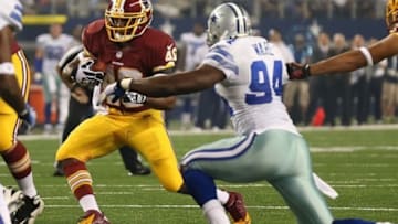 Oct 13, 2013; Arlington, TX, USA; Washington Redskins running back Alfred Morris (46) runs with the ball against Dallas Cowboys defensive end DeMarcus Ware (94) at AT&T Stadium.