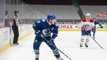 VANCOUVER, BC - JANUARY 20: Bo Horvat #53 of the Vancouver Canucks looks to make a pass while being defended against by Jonathan Drouin #92 of the Montreal Canadiens during NHL hockey action at Rogers Arena on January 20, 2021 in Vancouver, Canada. (Photo by Rich Lam/Getty Images)