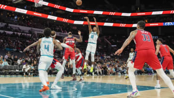 Oct 10, 2022; Charlotte, North Carolina, USA; Charlotte Hornets guard Dennis Smith Jr. (8) shoots a jumper over Washington Wizards guard Monte Morris (22) during the second half at Spectrum Center. Mandatory Credit: Jim Dedmon-USA TODAY Sports