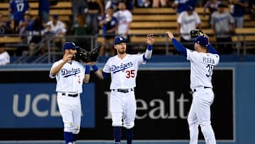 LOS ANGELES, CA - SEPTEMBER 04: Cody Bellinger #35, Joc Pederson #31and Chris Taylor #3 of the Los Angeles Dodgers celebrate after defeating the Colorado Rockies, 7-3, at Dodger Stadium on September 4, 2019 in Los Angeles, California. (Photo by Kevork Djansezian/Getty Images)