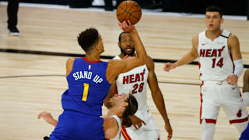 LAKE BUENA VISTA, FLORIDA - AUGUST 01: Kelly Olynyk #9 of the Miami Heat draws an offensive foul from Michael Porter Jr. #1 of the Denver Nuggets at HP Field House at ESPN Wide World Of Sports Complex on August 01, 2020 in Lake Buena Vista, Florida. NOTE TO USER: User expressly acknowledges and agrees that, by downloading and or using this photograph, User is consenting to the terms and conditions of the Getty Images License Agreement. (Photo by Kevin C. Cox/Getty Images)