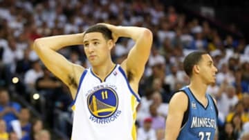 Apr 14, 2014; Oakland, CA, USA; Golden State Warriors guard Klay Thompson (11) reacts after being called for a foul against Minnesota Timberwolves guard Kevin Martin (23) during the second quarter at Oracle Arena. Mandatory Credit: Kelley L Cox-USA TODAY Sports